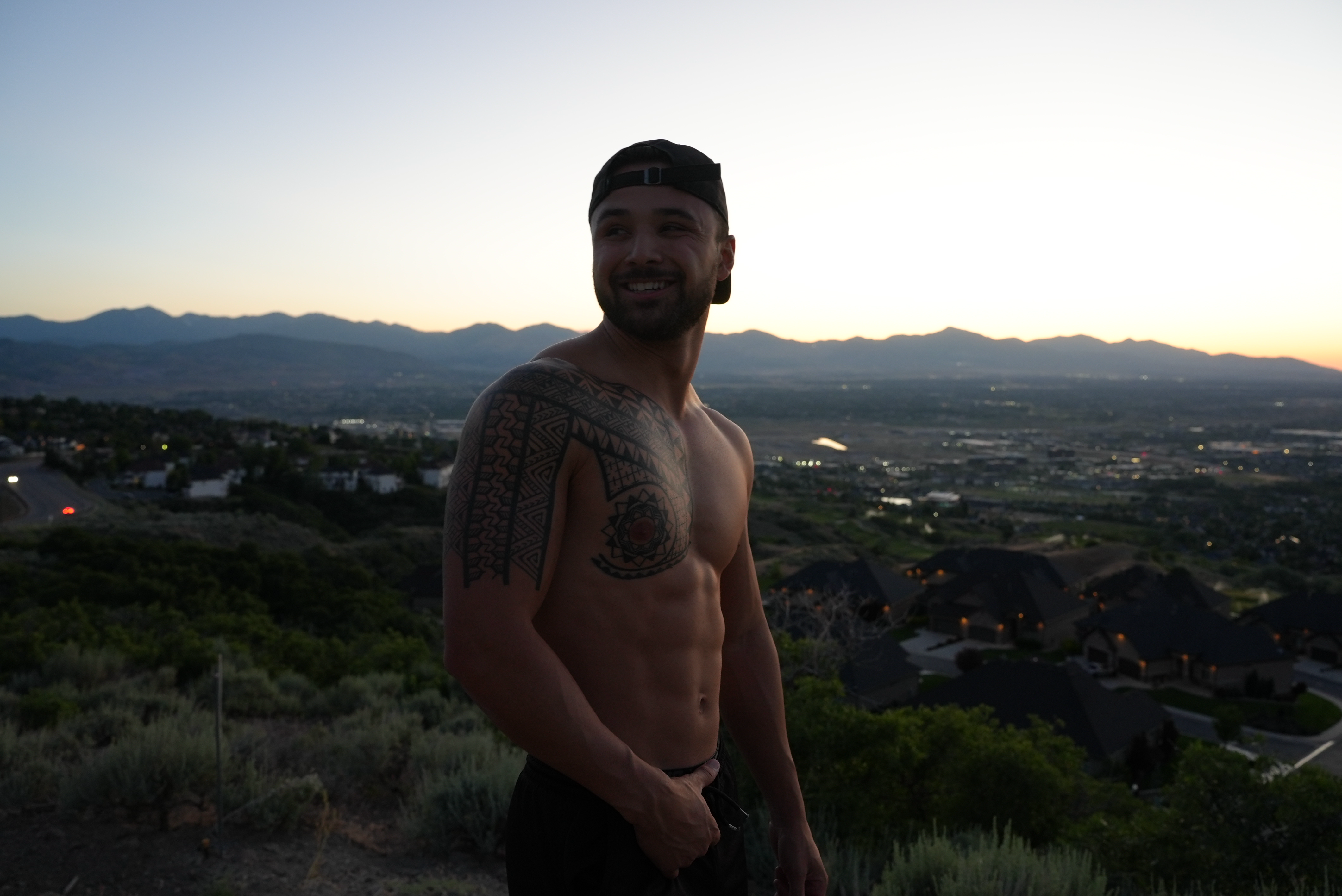 Sam smiling with mountain backdrop